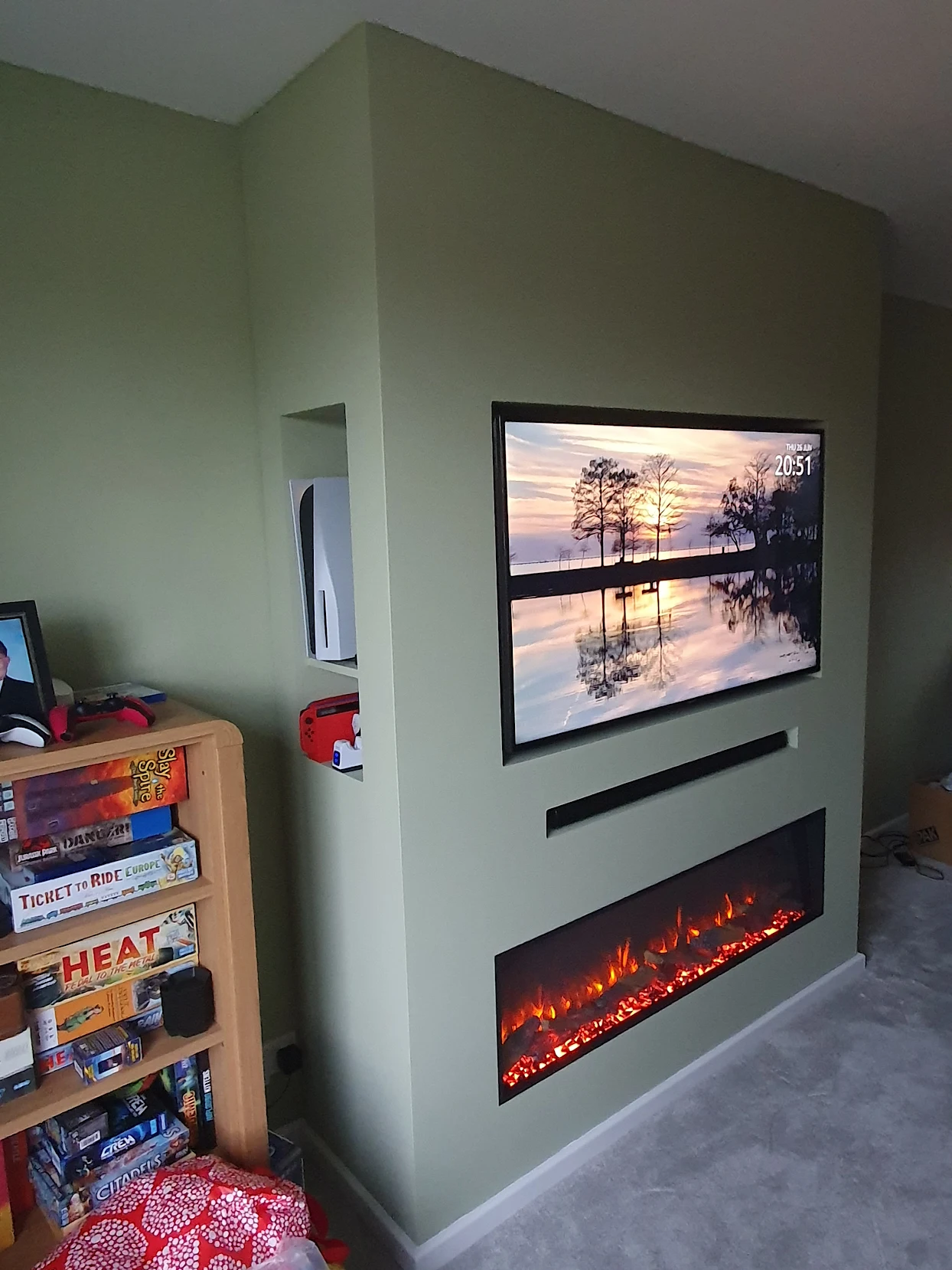 Sage green media wall with inset TV, soundbar slot and linear electric fire fitted by Warwickshire Media Walls for Wayne Mullins